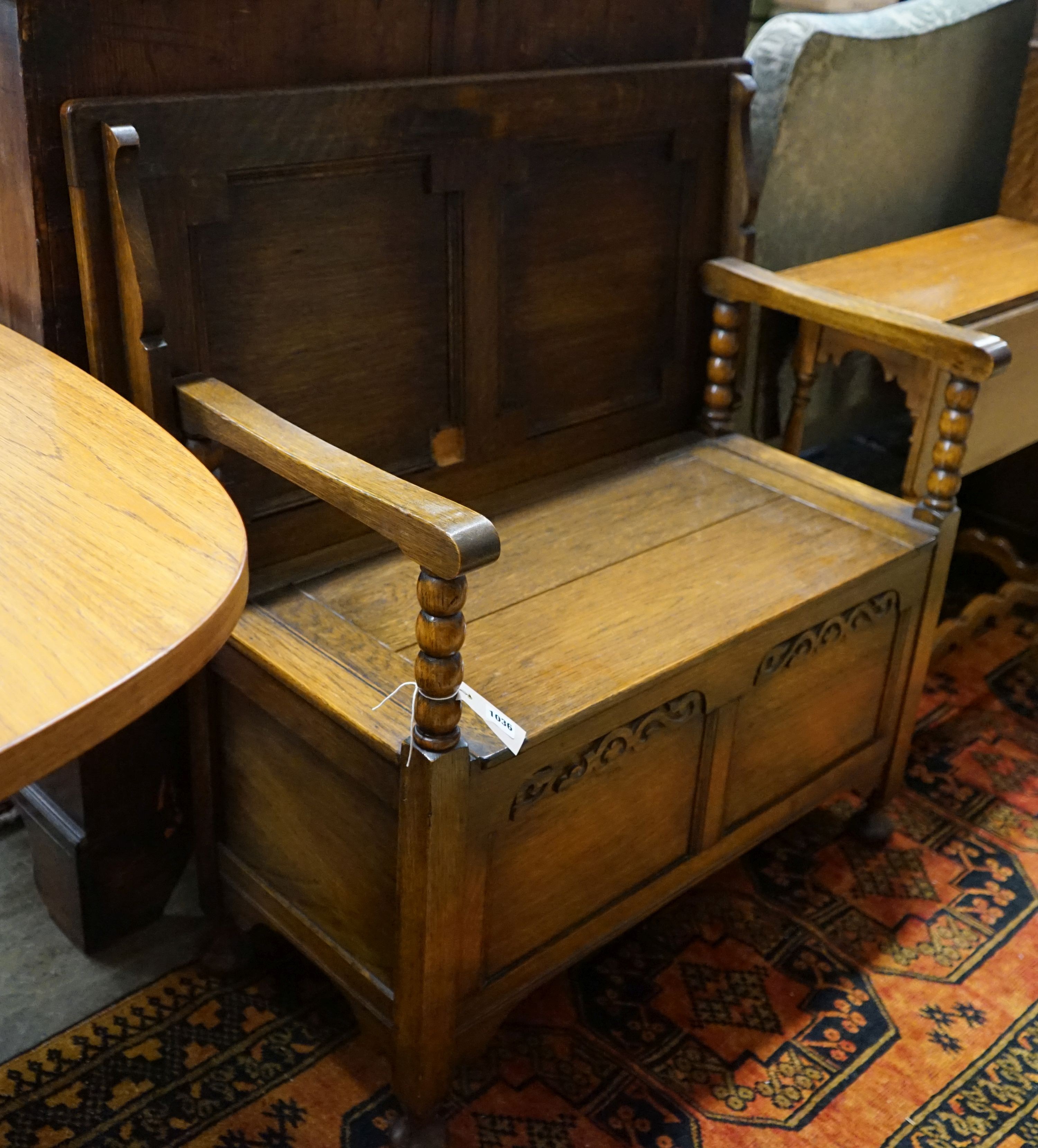 An oak monk's bench with folding top and locker seat, length 91cm, depth 47cm, height 92cm